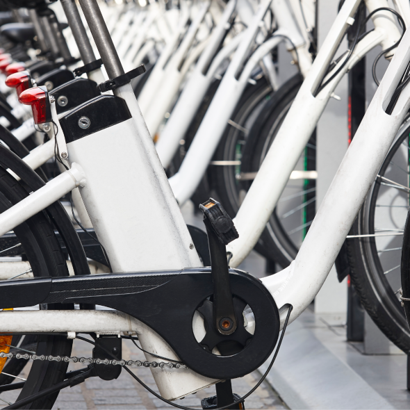 A row of docked electric bikes