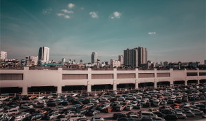 A view of a rooftop office parking lot full of cars