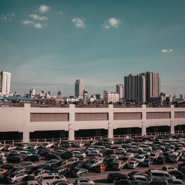 A view of a rooftop office parking lot full of cars